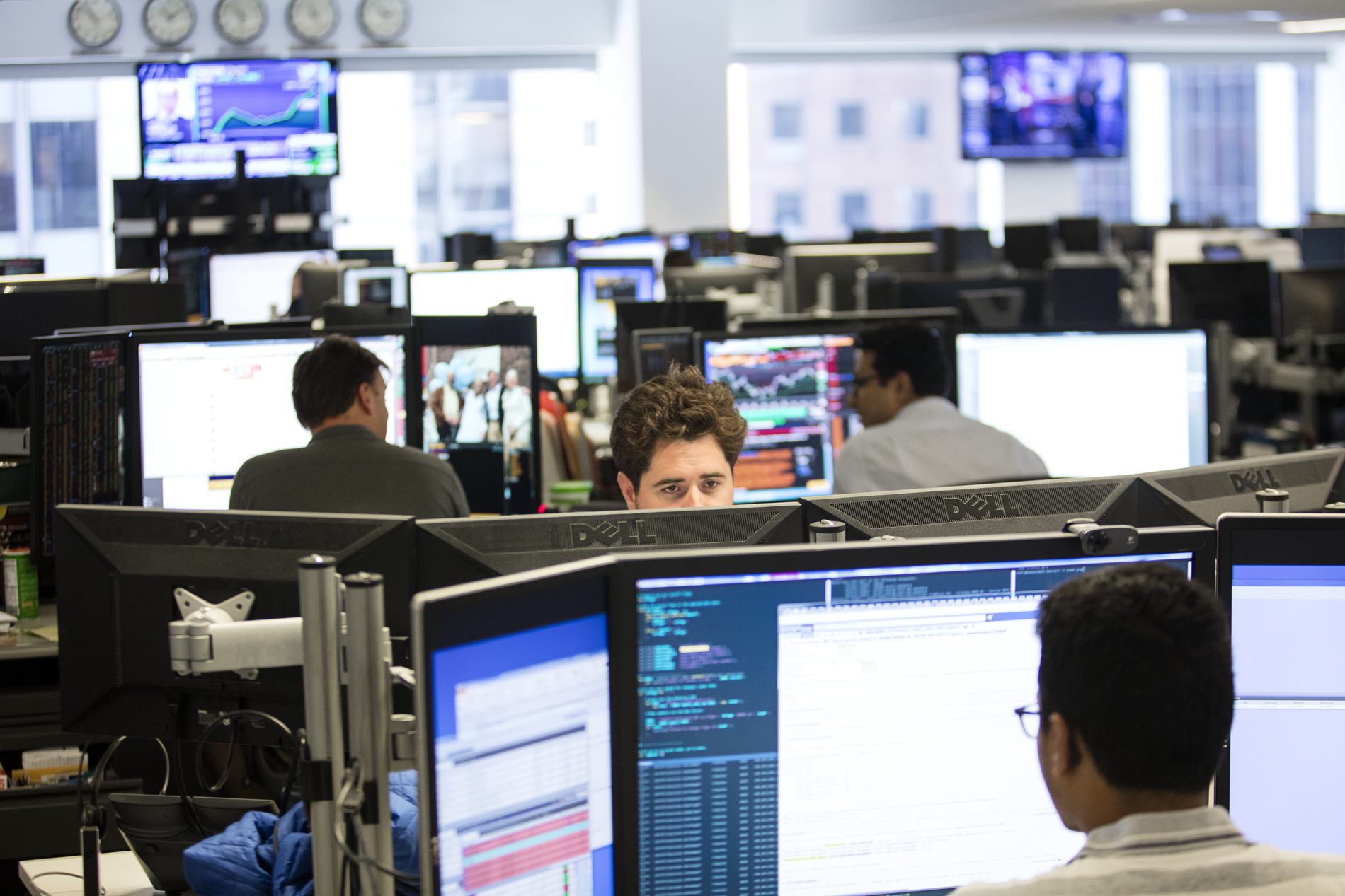 View of trading floor with several rows of workstations.
